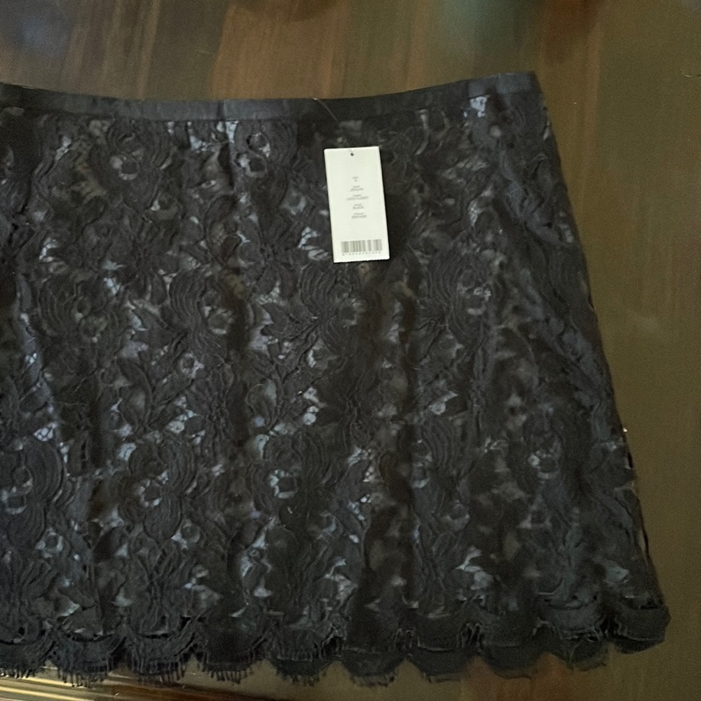 Never worn, with tags.  Theory mini skirt, cotton appliqué over dark gray slip…